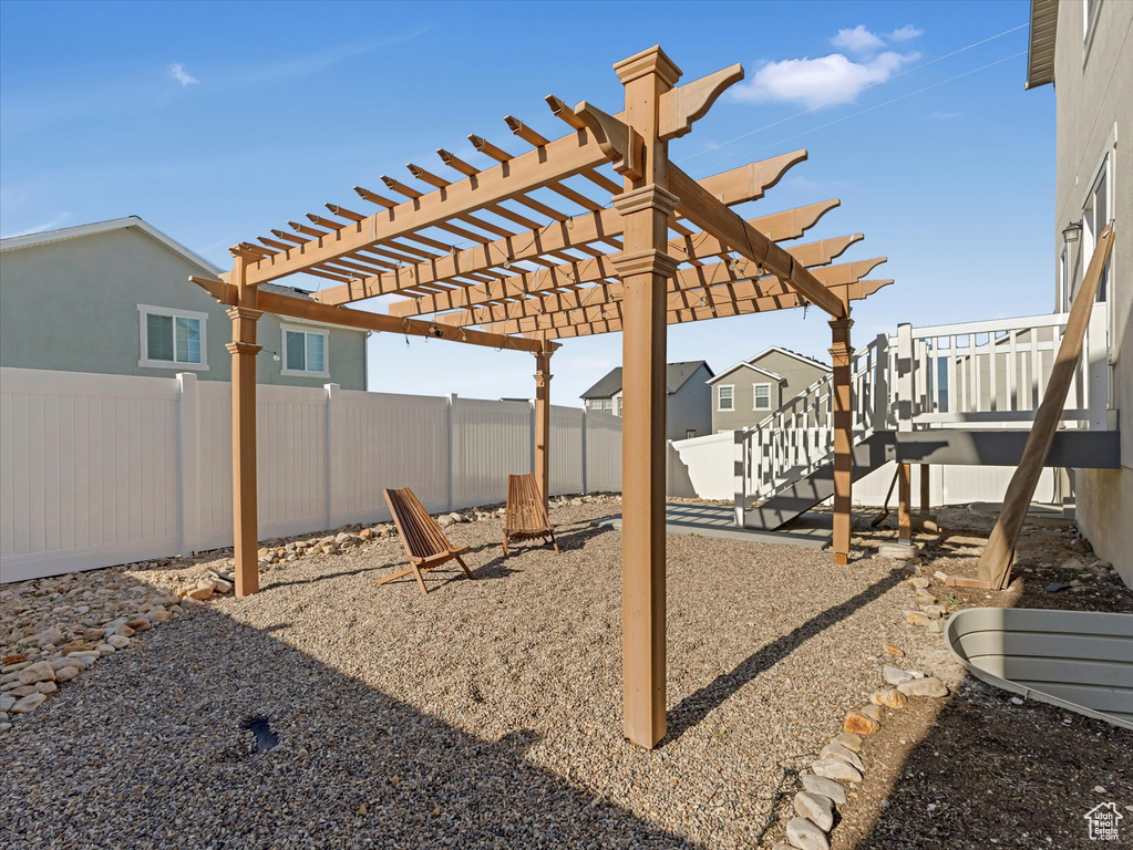 Fenced backyard with a pergola