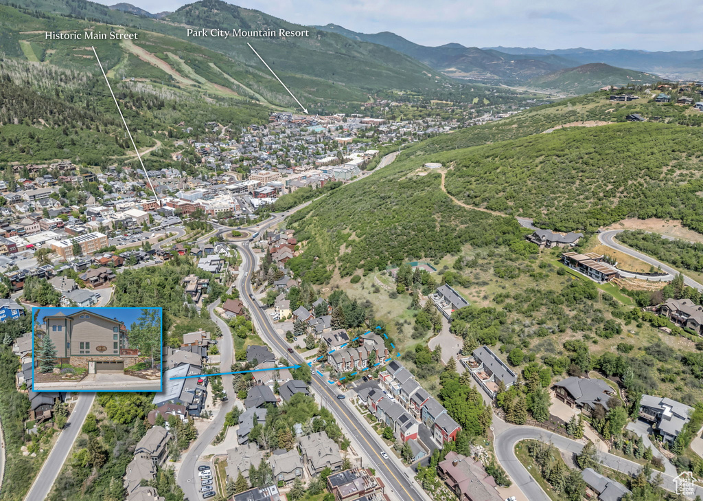 Aerial overview of property\'s location featuring a mountainous background and nearby suburban area