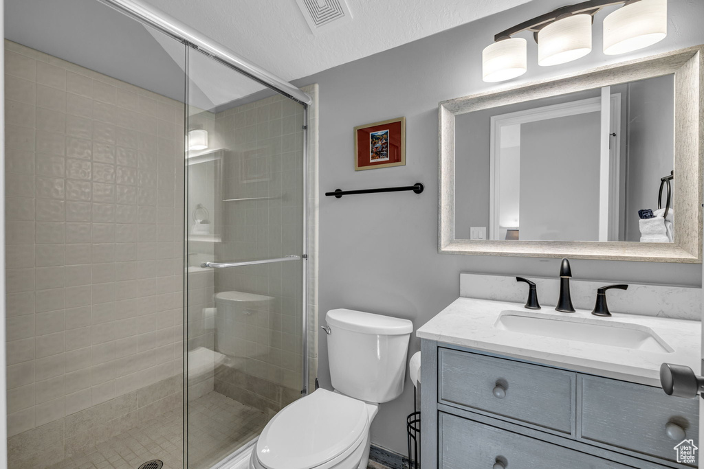 Bathroom featuring vanity and a shower stall