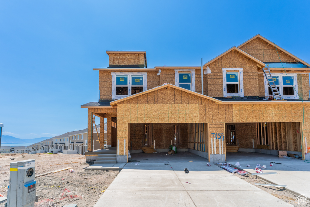 View of front of house featuring concrete driveway