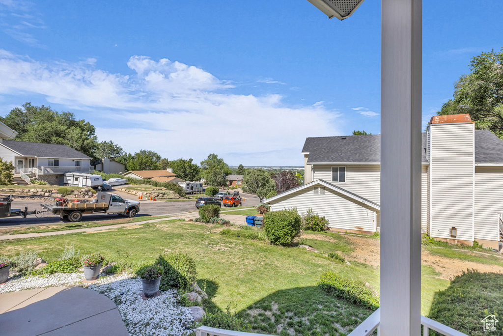 View of green lawn with a residential view