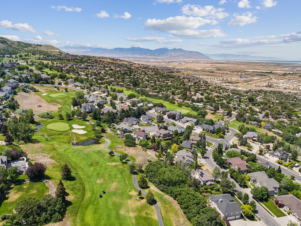 View of property location featuring mountains, nearby suburban area, and a golf club