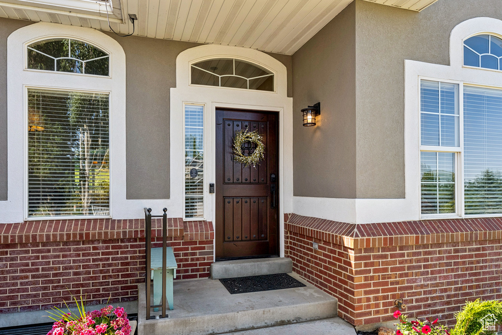 Entrance to property featuring stucco siding and brick siding