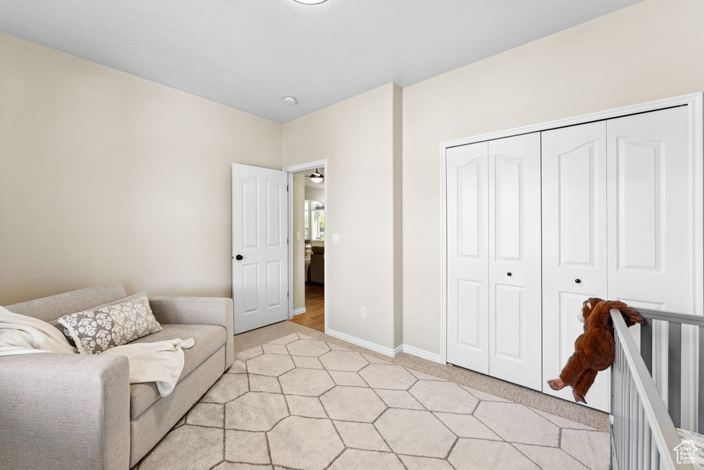Sitting room with light colored carpet and baseboards