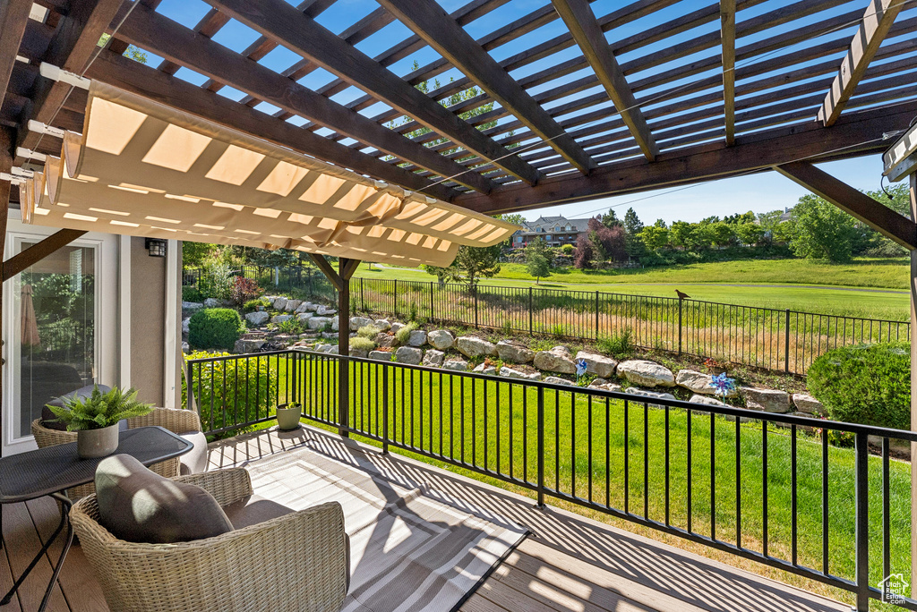 Deck featuring a fenced backyard and a pergola