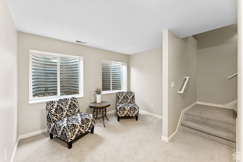 Living area featuring carpet floors and stairway