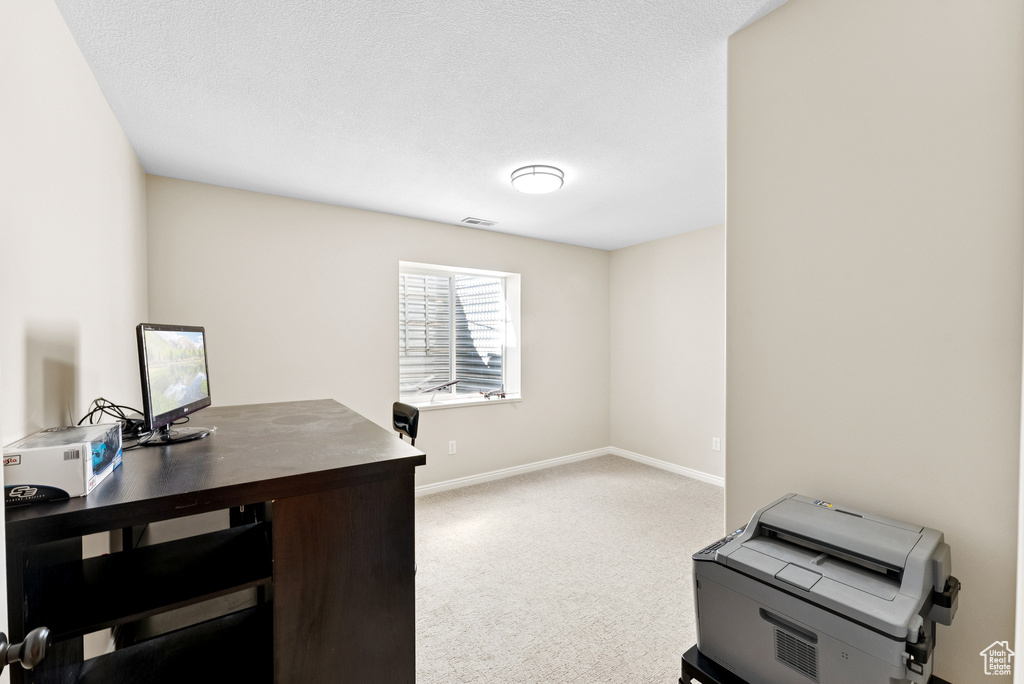 Office area with baseboards and carpet flooring