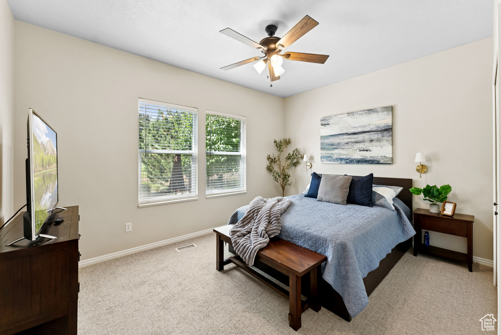 Bedroom featuring light colored carpet and ceiling fan