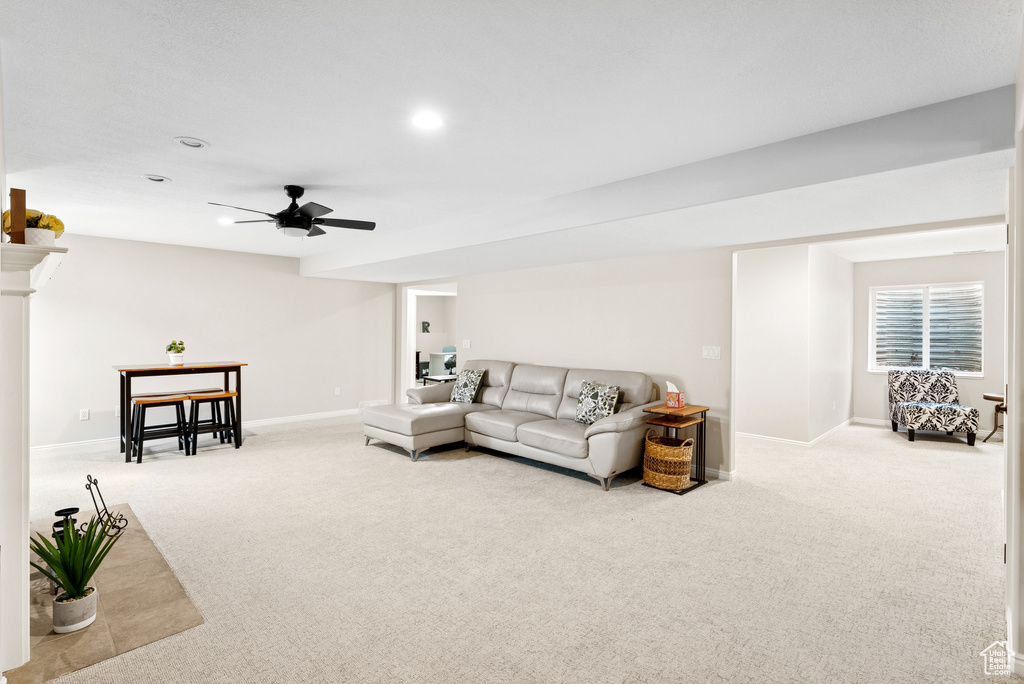 Living area featuring carpet flooring, ceiling fan, and recessed lighting