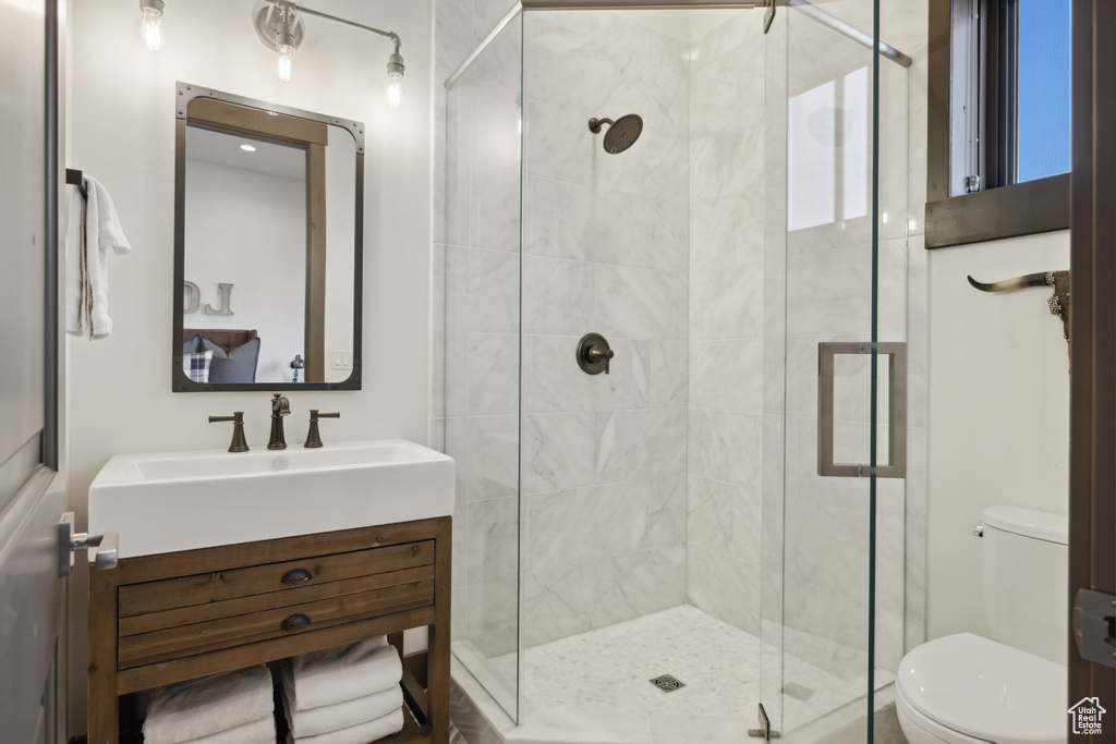 Bathroom featuring vanity and a shower stall