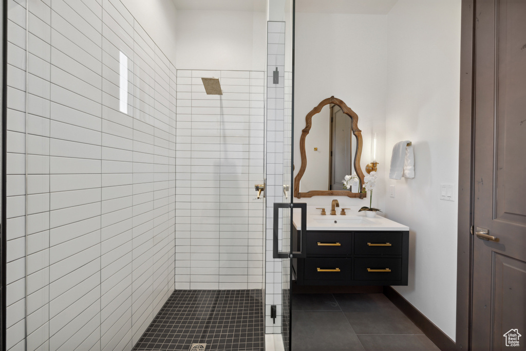 Bathroom with a stall shower, vanity, and tile patterned flooring