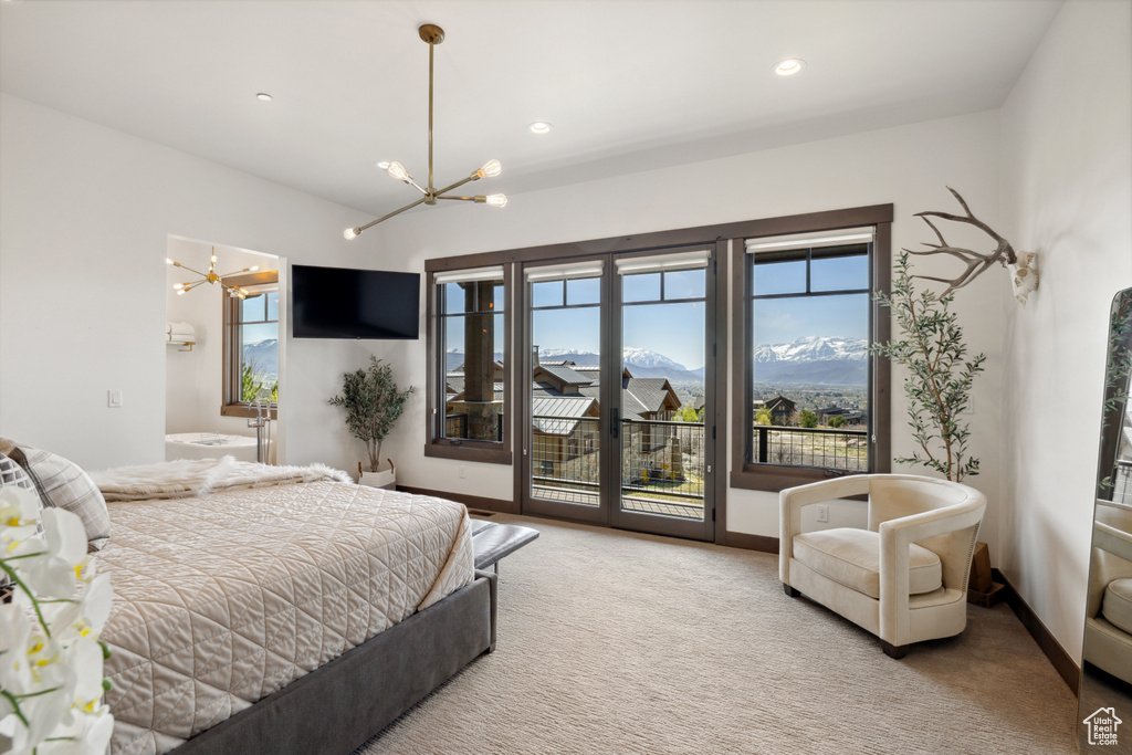 Carpeted bedroom featuring a chandelier, access to outside, recessed lighting, and ensuite bathroom
