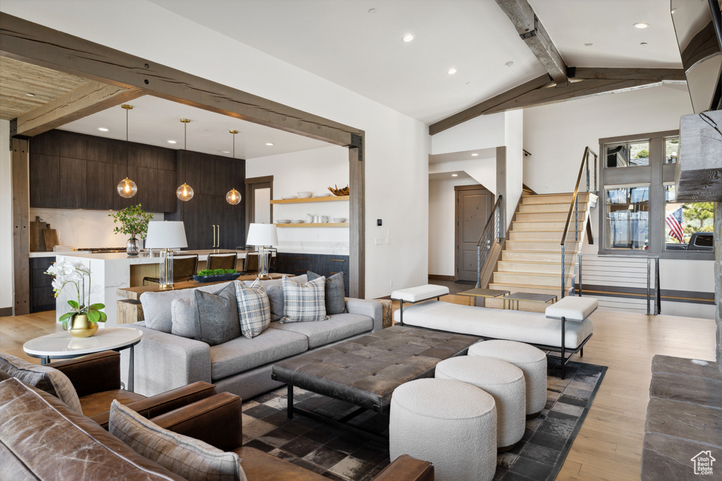Living area featuring light wood-style floors, recessed lighting, and stairs
