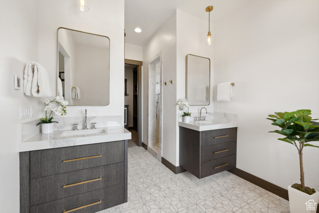 Full bathroom with two vanities and recessed lighting