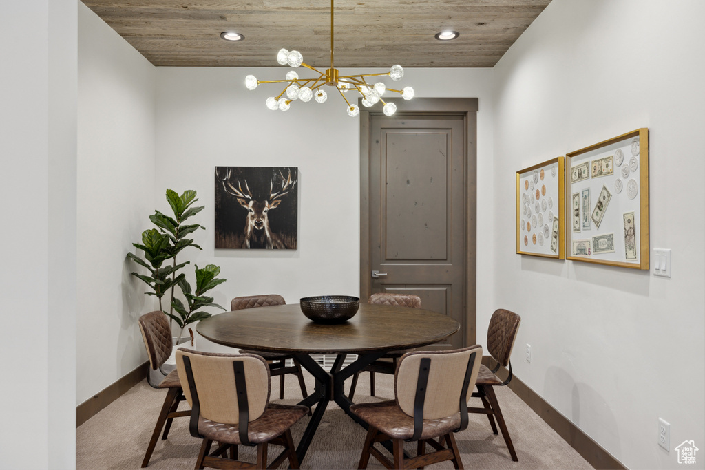 Dining area featuring light carpet, a chandelier, recessed lighting, and wooden ceiling