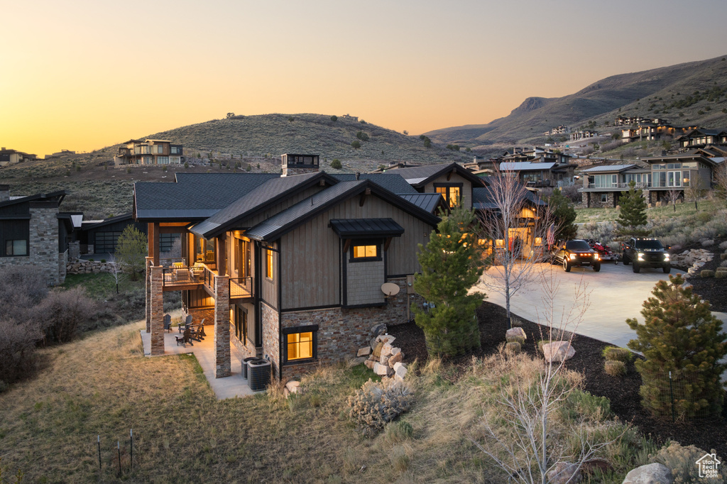 View of front facade featuring a mountain view and concrete driveway