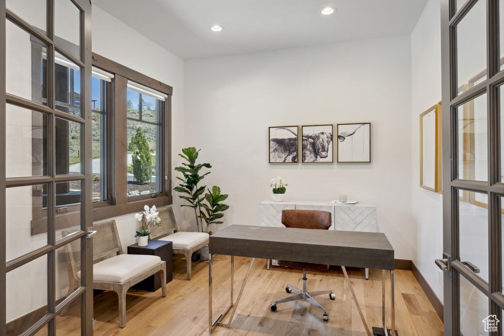 Office space with wood finished floors, french doors, and recessed lighting