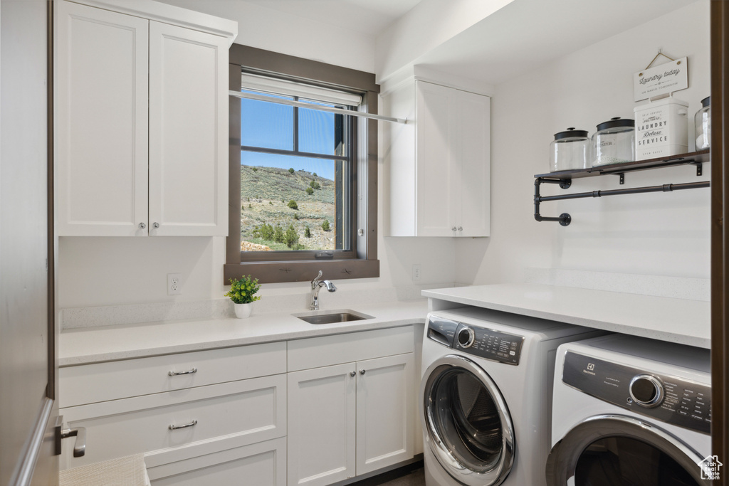 Laundry area with cabinet space and washing machine and dryer