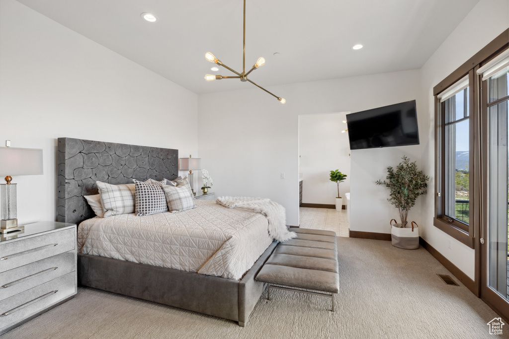 Carpeted bedroom with a chandelier and recessed lighting