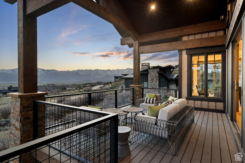 Deck with a mountain view and an outdoor hangout area