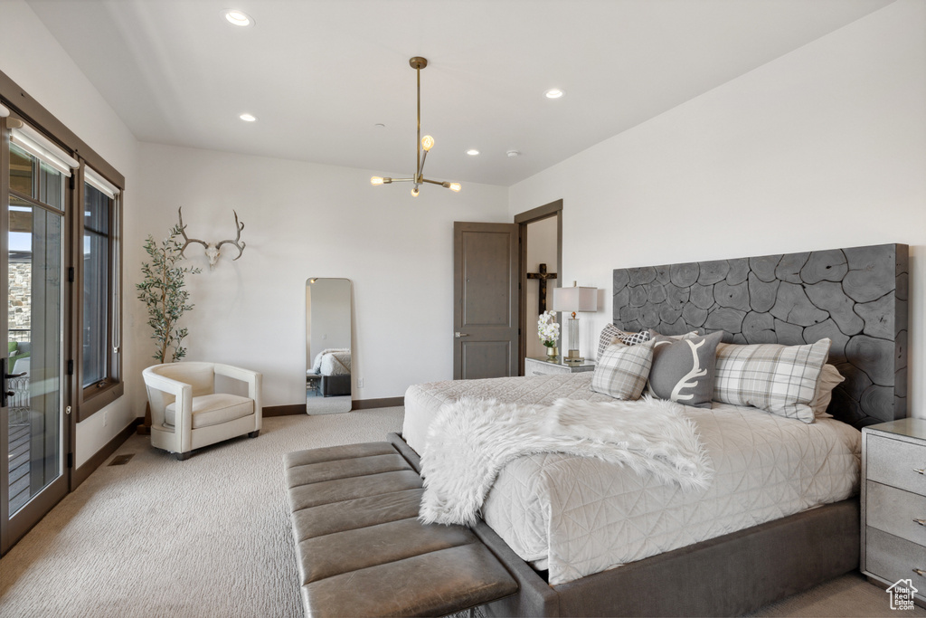 Bedroom featuring light colored carpet, a chandelier, recessed lighting, and access to exterior