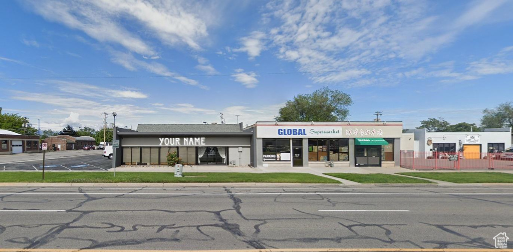 View of commercial property featuring uncovered parking