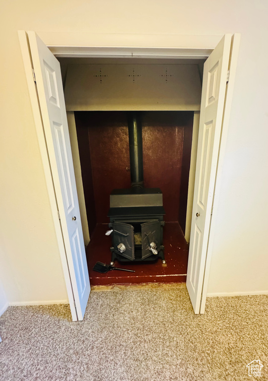 Detailed view of carpet flooring and a wood stove