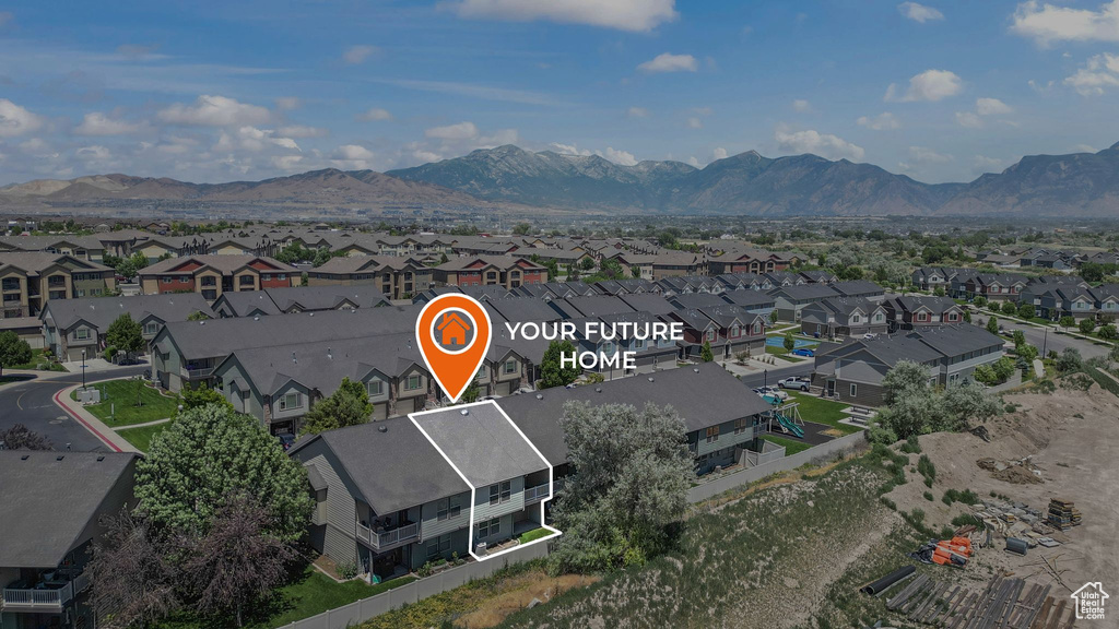 Aerial overview of property's location featuring nearby suburban area and a mountain backdrop