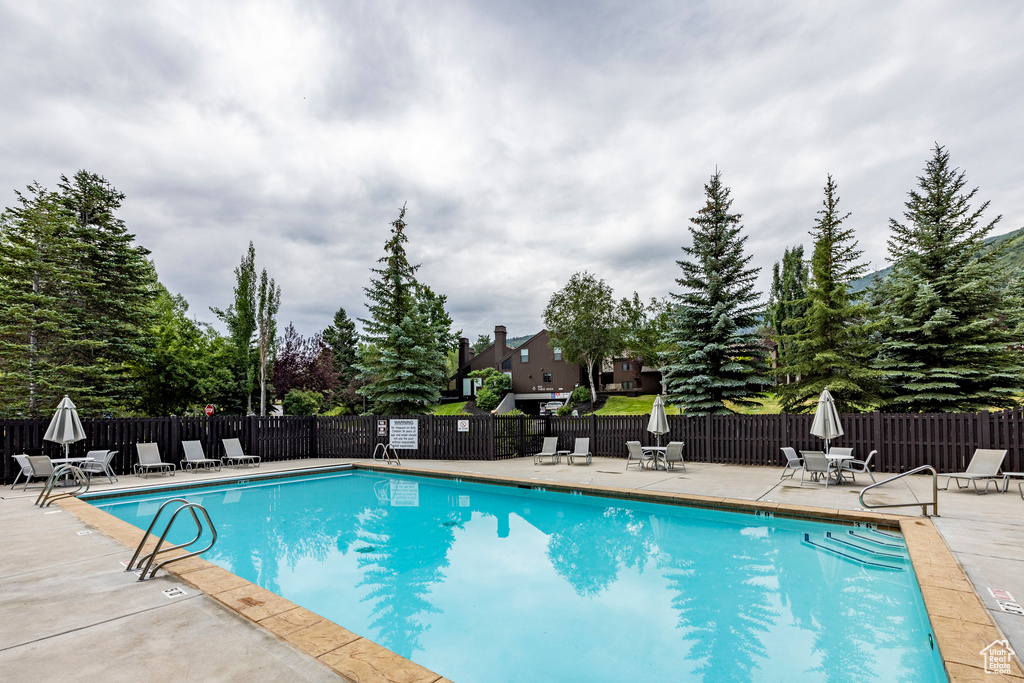 Community pool with a patio