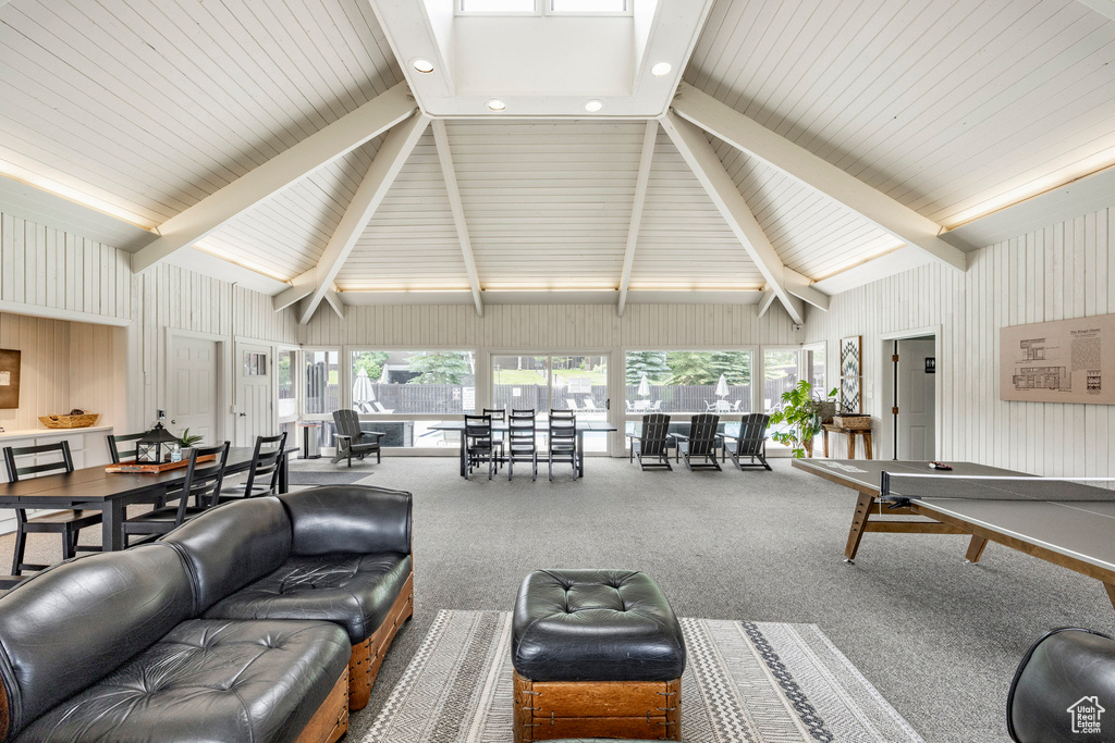 Living area with beamed ceiling, carpet flooring, recessed lighting, and high vaulted ceiling