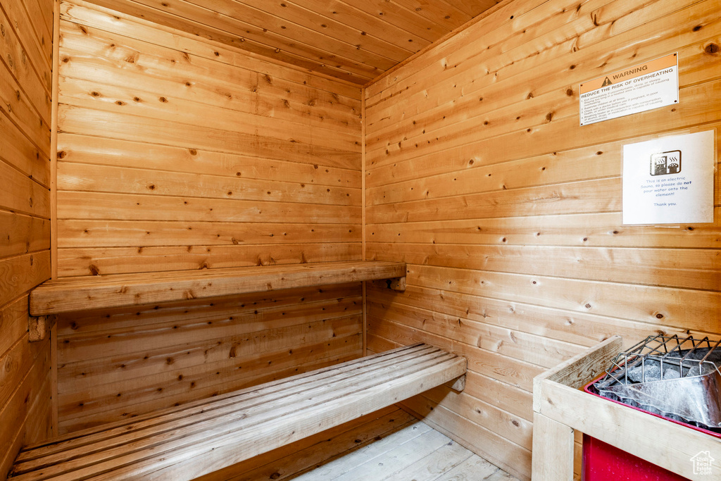 Sauna featuring wooden walls and wooden ceiling