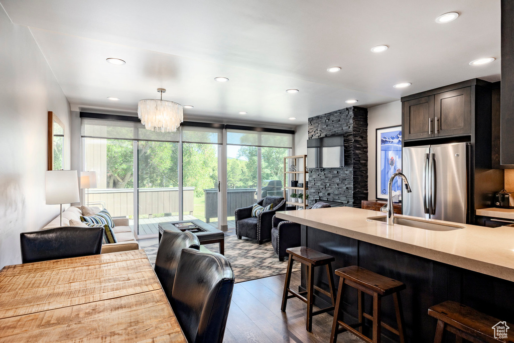 Kitchen featuring open floor plan, freestanding refrigerator, hardwood / wood-style flooring, healthy amount of natural light, and recessed lighting