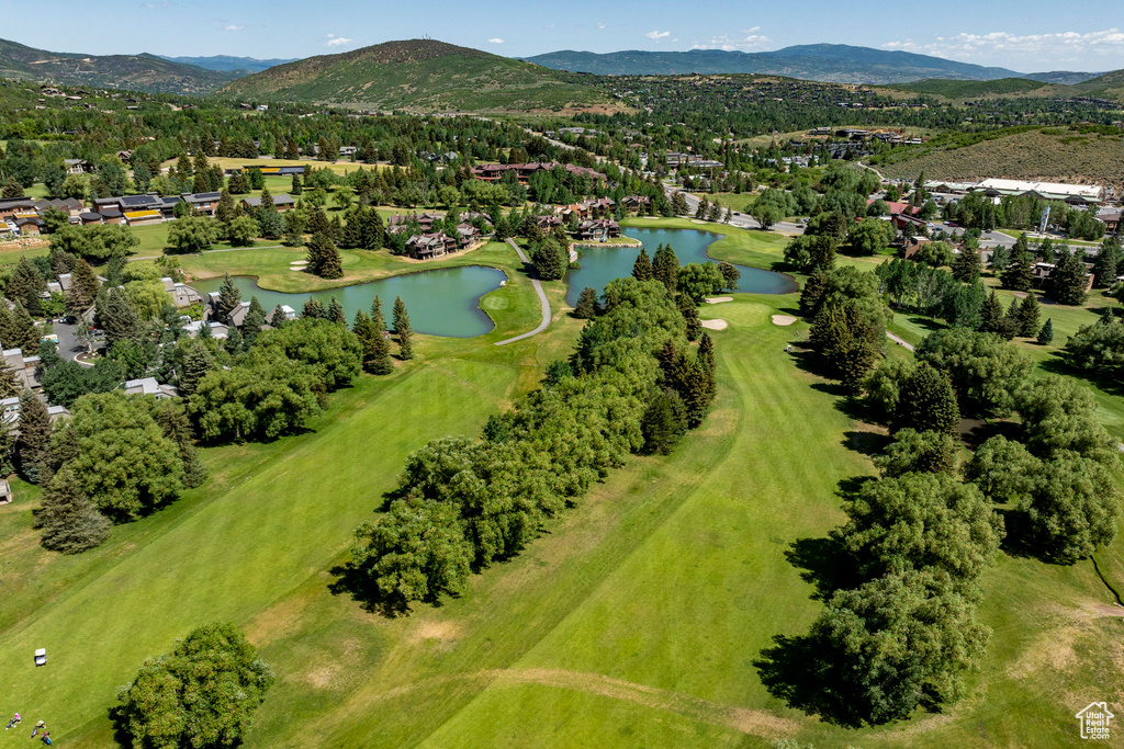 Aerial view of property's location featuring a water and mountain view and nearby suburban area