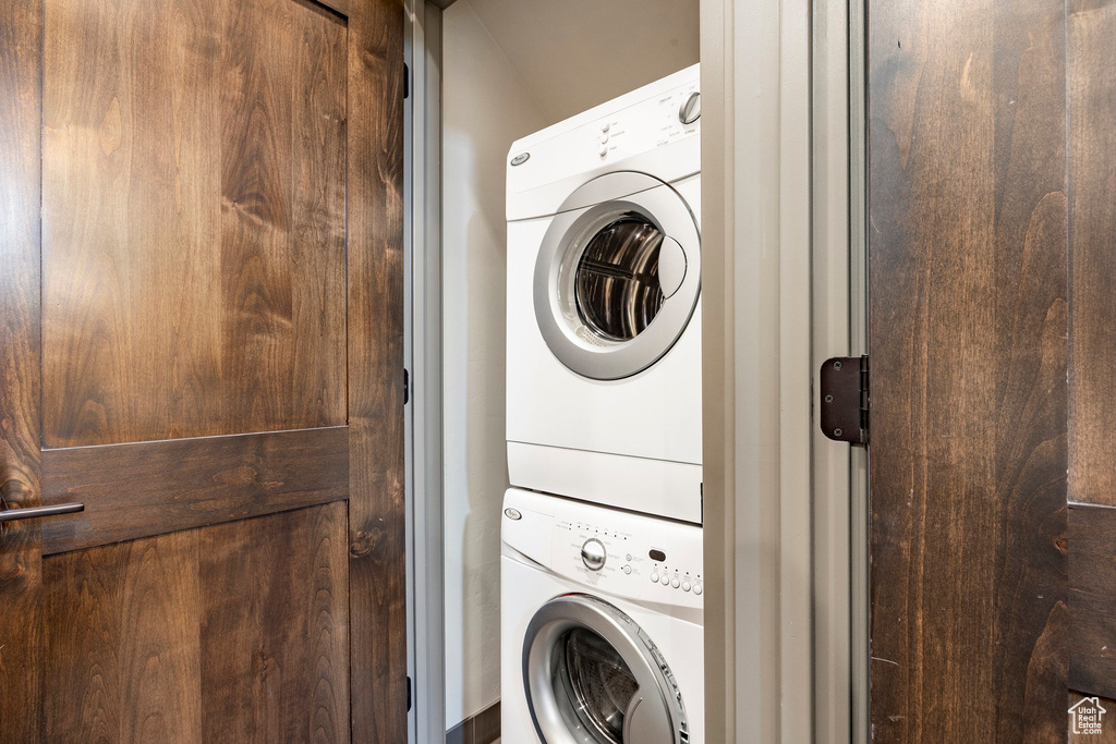 Laundry room with stacked washing machine and dryer
