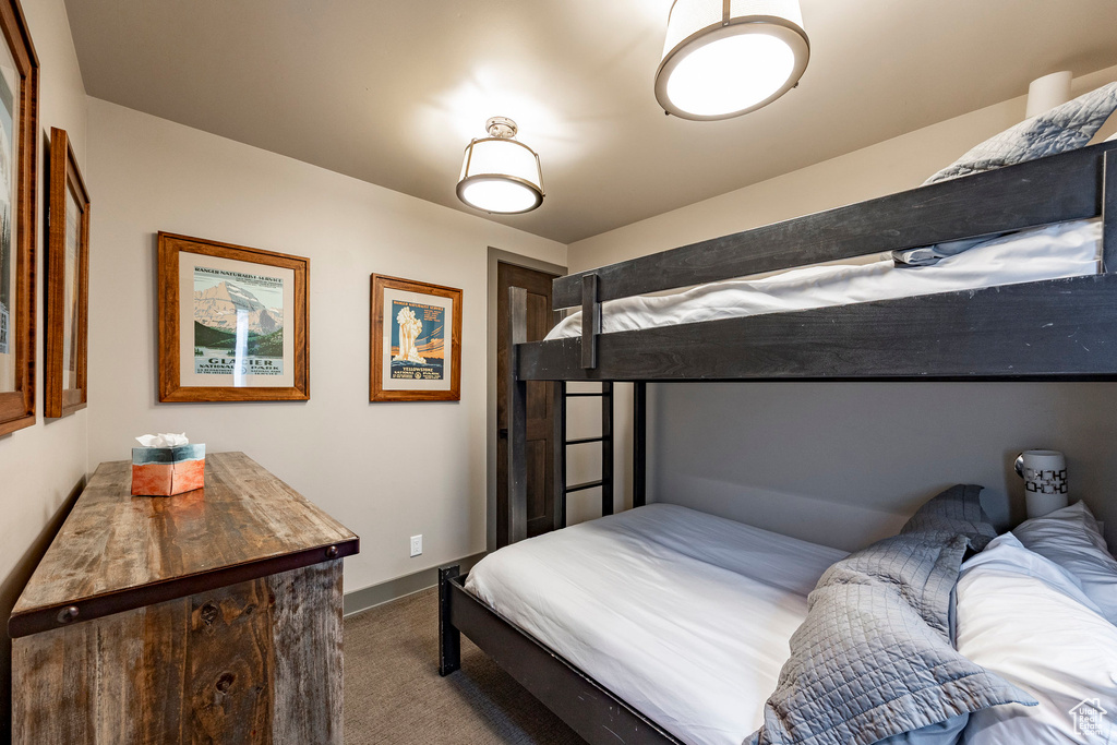 Bedroom with carpet flooring and baseboards