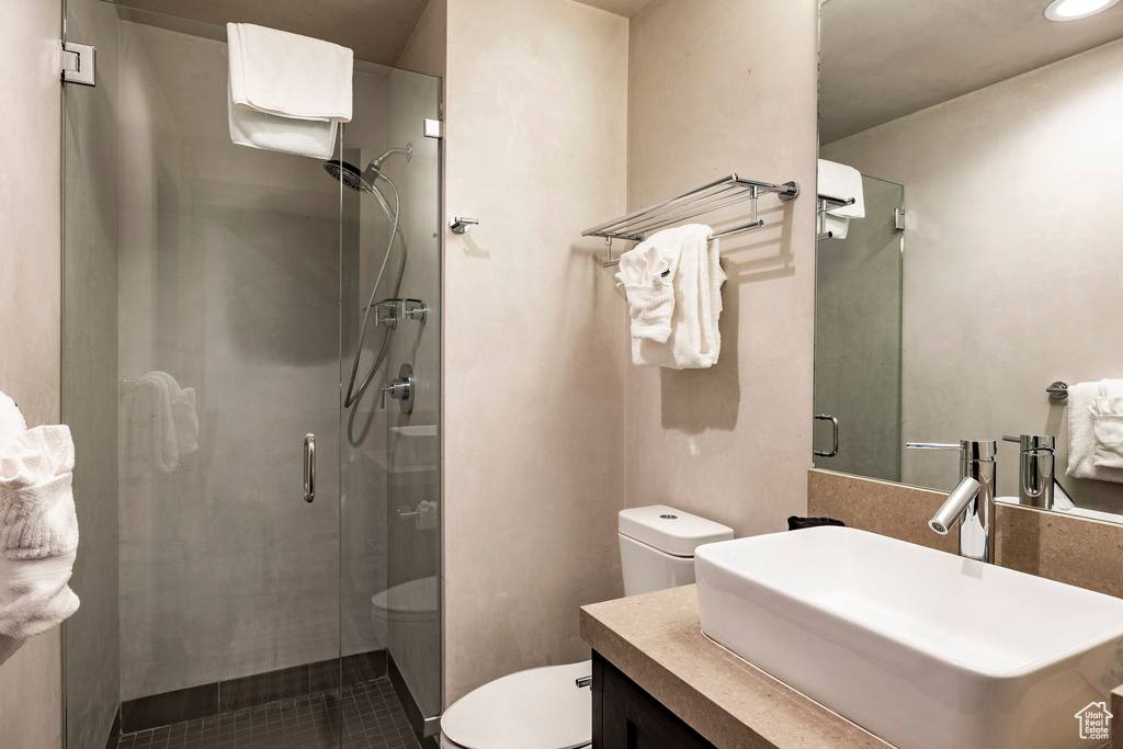 Bathroom with a shower stall, vanity, tile patterned floors, and recessed lighting