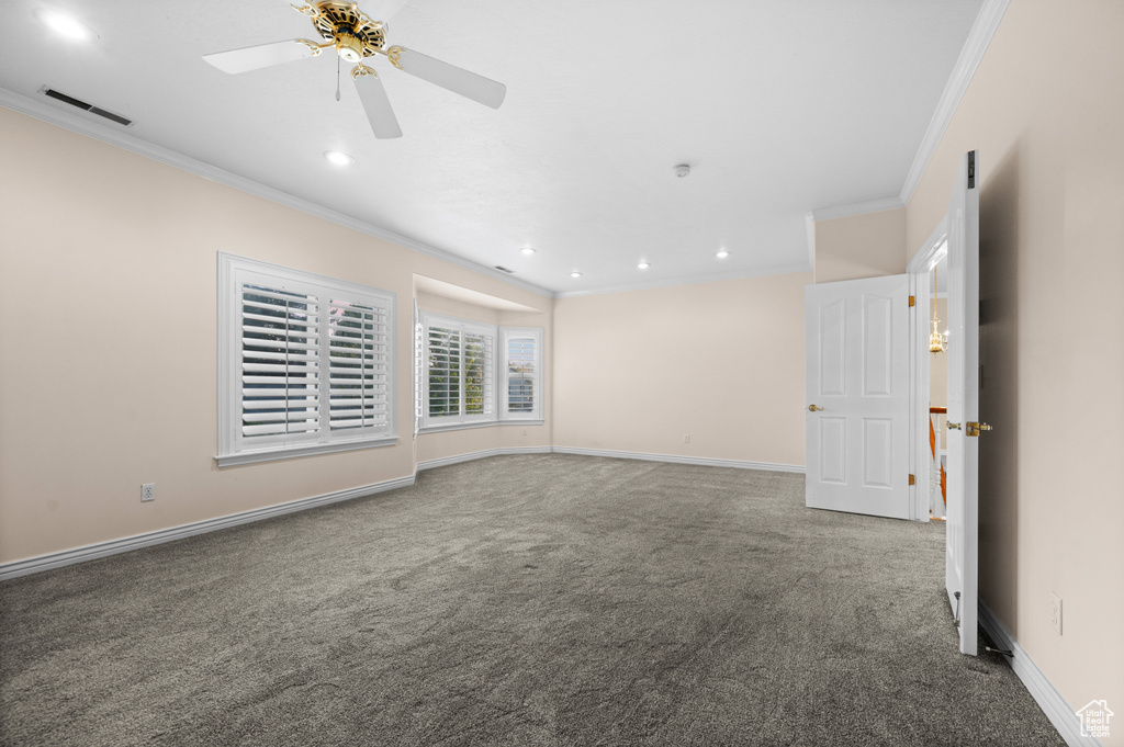 Carpeted spare room with ornamental molding, a ceiling fan, and recessed lighting