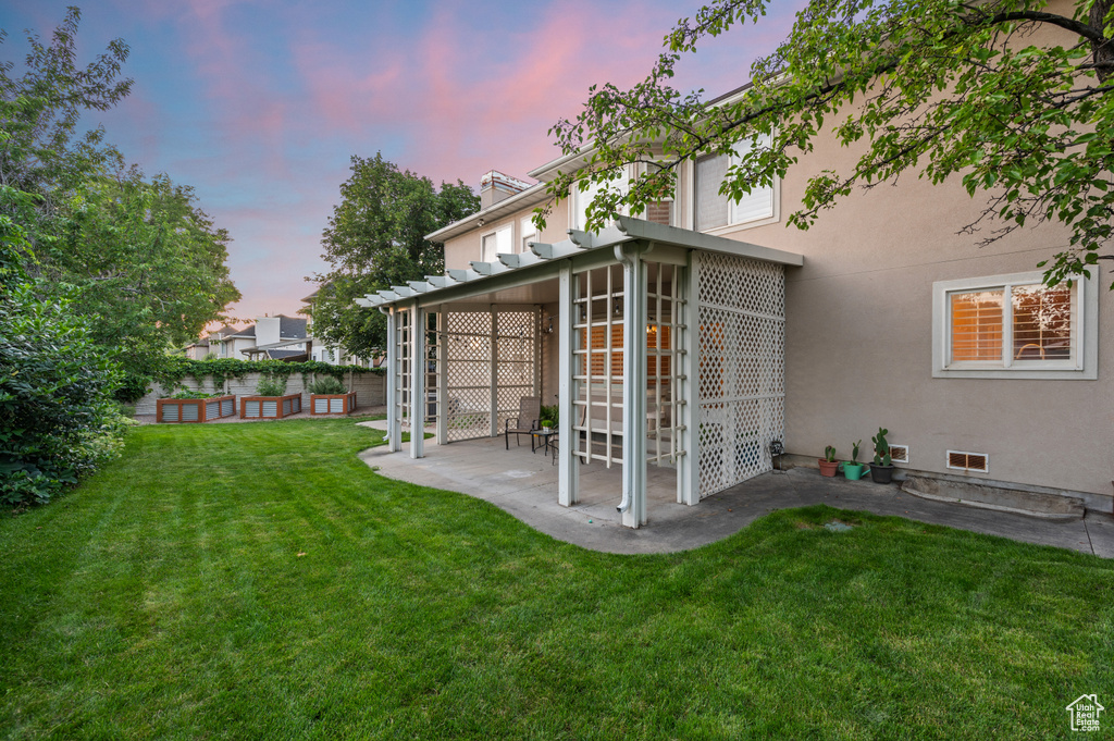View of grassy yard with a patio