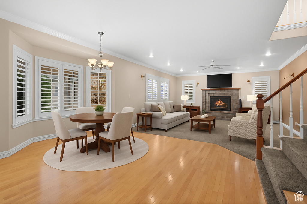 Dining area featuring light wood-type flooring, a brick fireplace, recessed lighting, a ceiling fan, and stairs