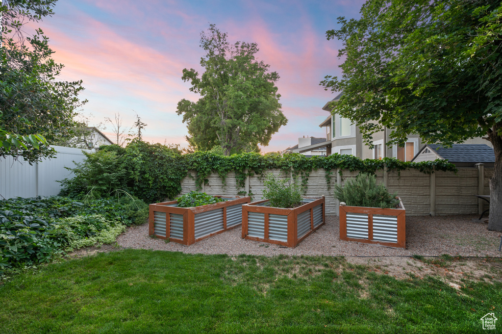 Fenced backyard with a garden