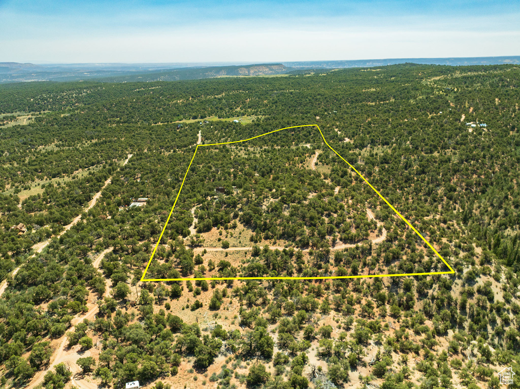 Aerial view of sparsely populated area with property parcel outlined