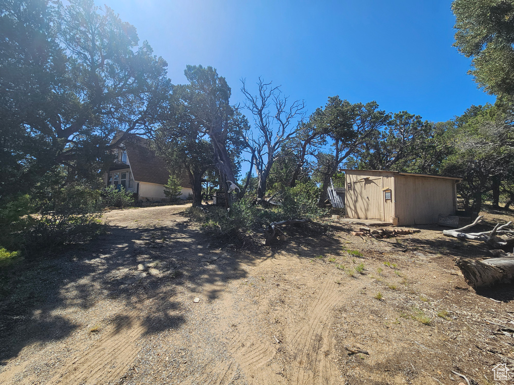 View of yard featuring a storage unit