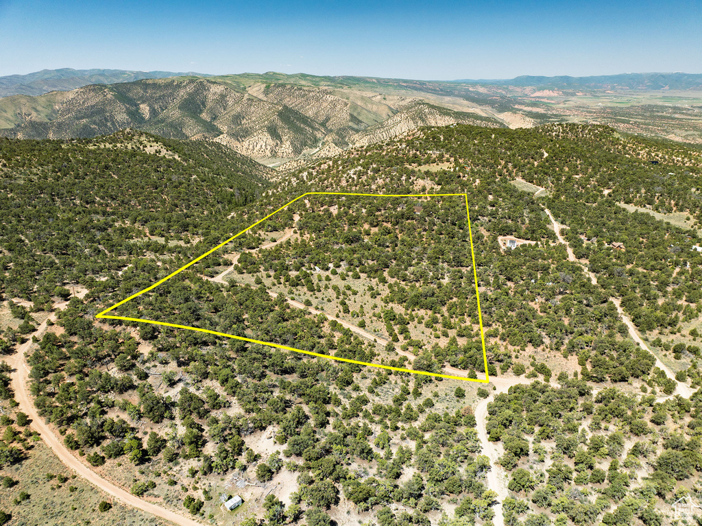 Aerial view of property's location featuring a mountainous background and property boundaries highlighted