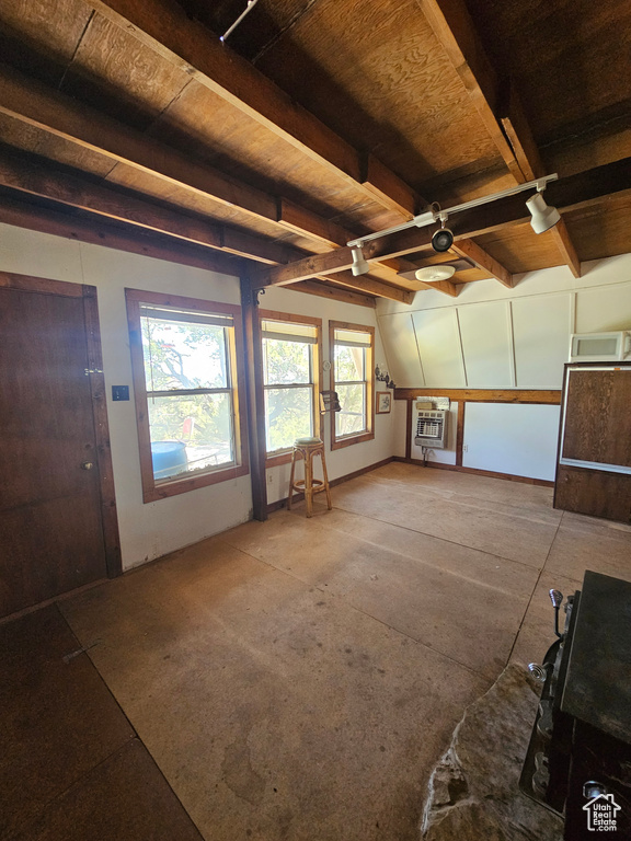 Unfurnished living room featuring a wood ceiling with exposed beams and a ceiling fan