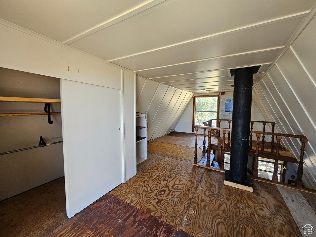Additional living space with lofted ceiling and wood finished floors