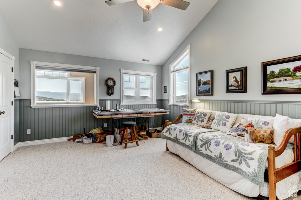 Bedroom with vaulted ceiling, wainscoting, carpet floors, ceiling fan, and recessed lighting