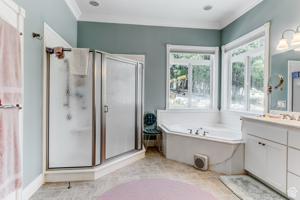 Full bath featuring vanity, a stall shower, a bath, and crown molding