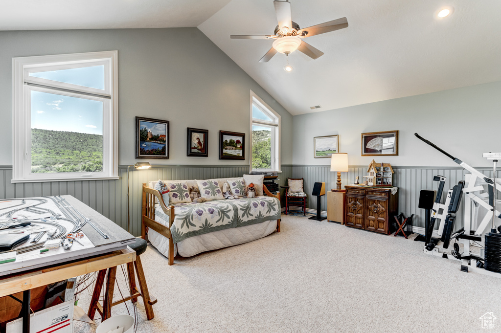 Carpeted bedroom with wainscoting, ceiling fan, high vaulted ceiling, and recessed lighting