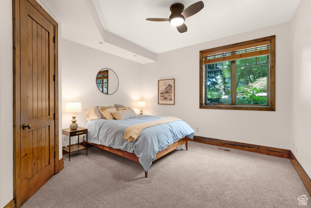 Carpeted bedroom with baseboards and ceiling fan