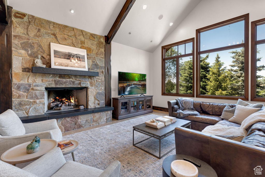 Living area featuring a fireplace, high vaulted ceiling, beamed ceiling, and recessed lighting